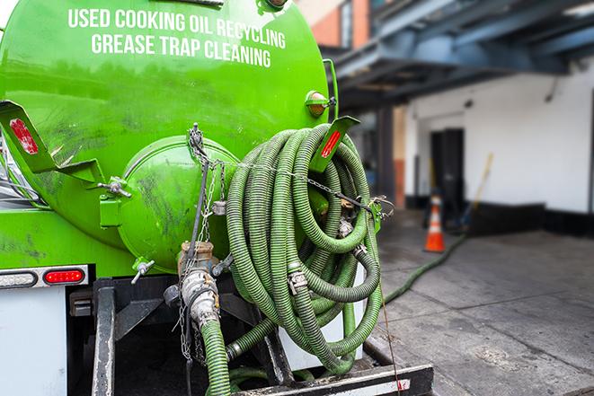 a large industrial grease trap being pumped out in Arlington VA